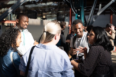 Attendees mingling and chatting in the break between talks.