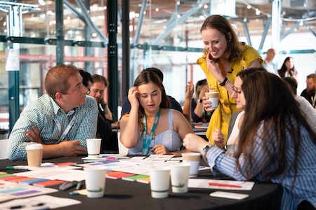 Workshop attendees gathered at a table getting hands-on instruction from Aleks Melnikova.