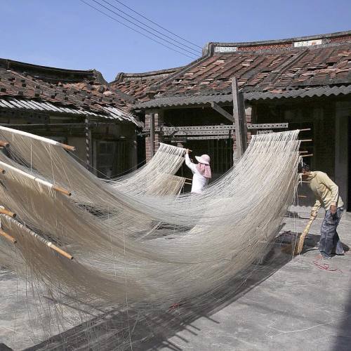 100sss:
“A woman hangs handmade noodles to dry in the sunlight in Fuxing town Changhua Country, Taiwan on January 12th 2016.
”