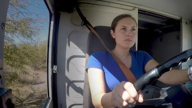 USPS Rural Carrier Associate driving a vehicle.