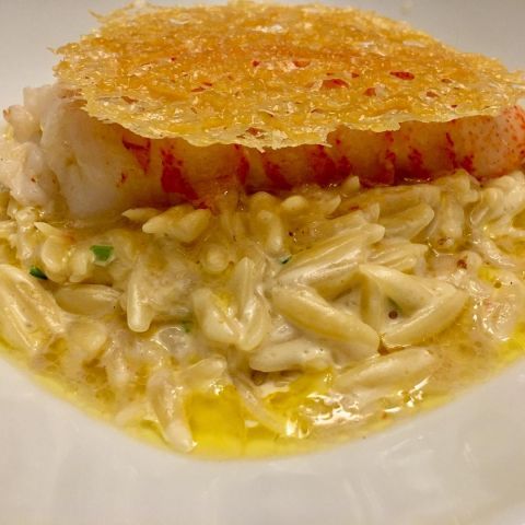 Lobster tail on orzo with a Parmesan crisp.