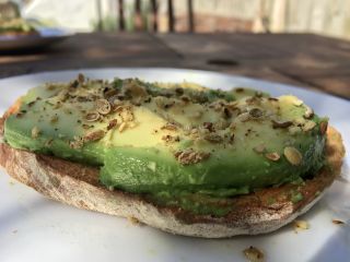 Eating toast (with avocado and dukkah) in the back garden.