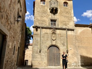 Jessica in front of a beautiful old medieval tower.