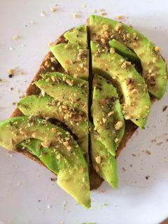 Eating toast (with avocado and dukkah).