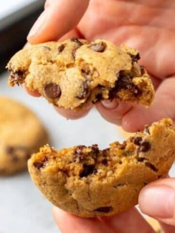 Cookie being broken open to show filled with chocolate.