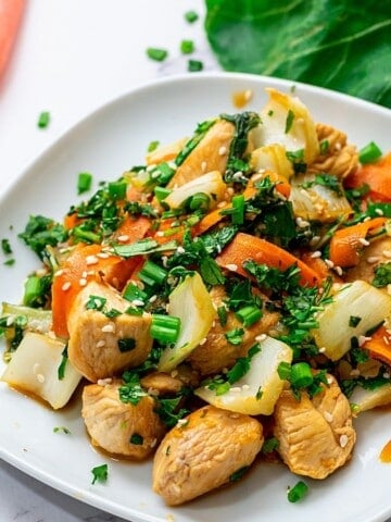 Plate of chicken and bok choy stir fry topped with cilantro.