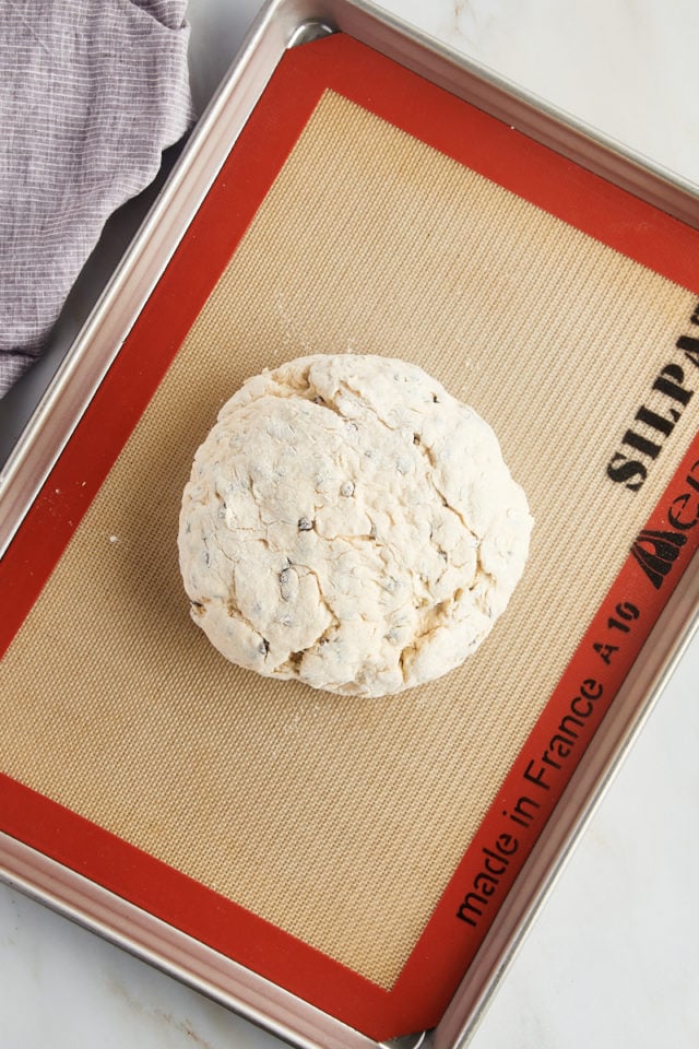 overhead view of Irish soda bread on a baking sheet lined with a silicone mat