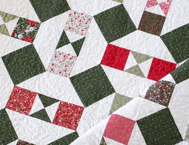 The "Somersault" charm pack quilt from the Charm School book by Vanessa Goertzen of Lella Boutique. Looks like a Christmas ornament quilt In Berry & Pine fabric.