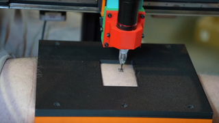 Emily The Engineer's 3D printer-tattoo-machine mod emblazoning her friend's leg with "leg".