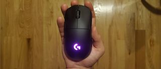 hand holding wireless logitech gaming mouse