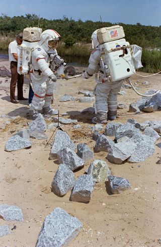 apollo 17 lunar landing mission, astronauts practice surveying the environment in spacesuits on Earth. astronaut Eugene A. Cernan (on the left) and Harrison H. Schmitt (on the right).