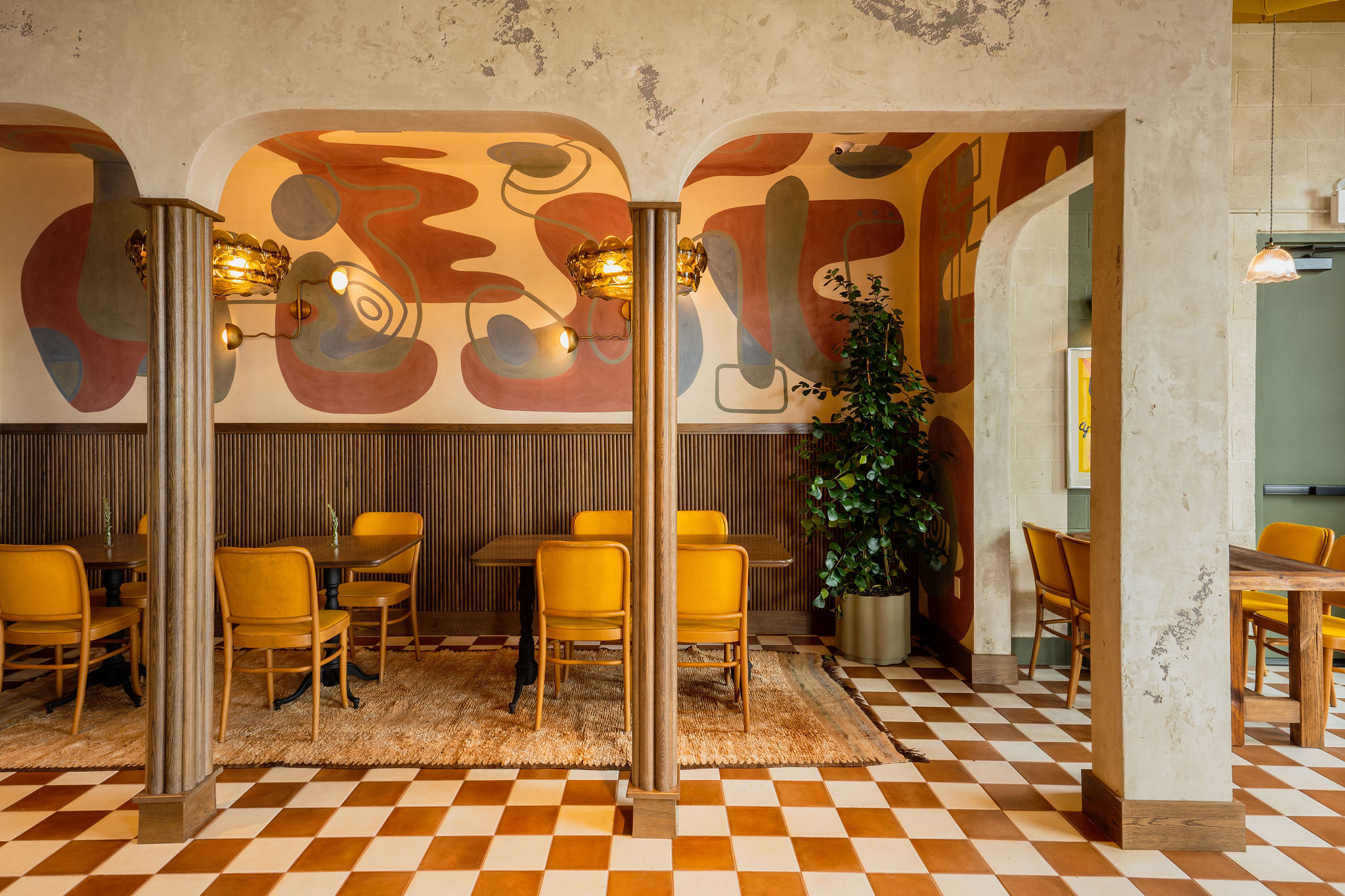 Tables and chairs inside a wine bar.