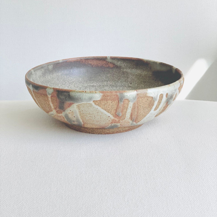 Rustic serving bowl with splattered white glaze by Cloude Made