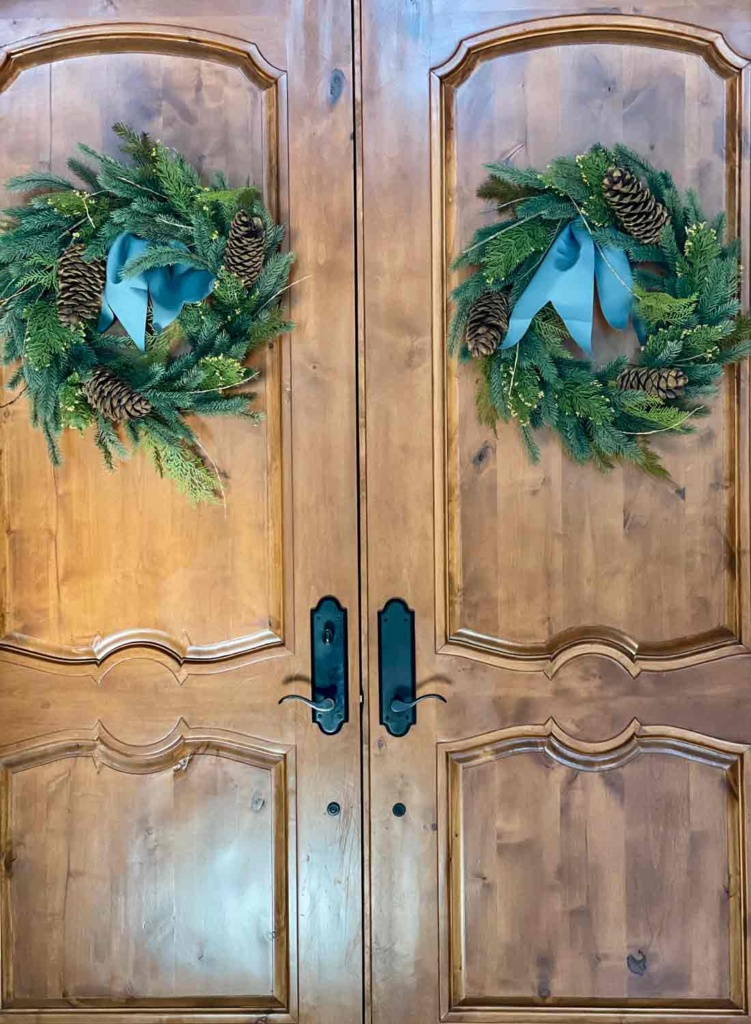 FRONT DOORS WITH CHRISTMAS WREATHS WITH WIDE BLUE RIBBON