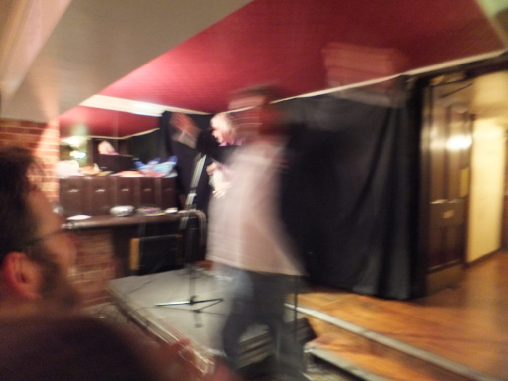 Phill Jupitus leaps around in front of JTA.