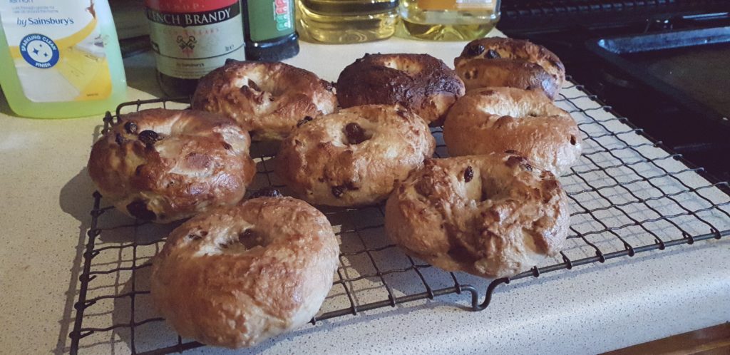 Cooling rack full of rustic bagels.