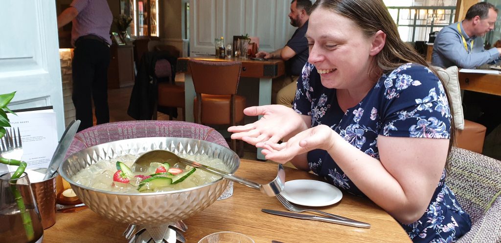 Ruth sits in awe of a bowl of gin cocktail.