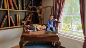 The kids on an enormous chair.