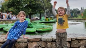 Kids at the "frog" fountains near the entrance to Alton Towers' theme park.