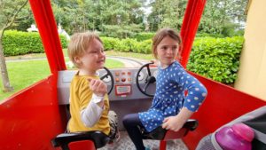 The kids drive through the Postman Pat ride.