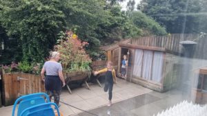 Children running out of a shed.