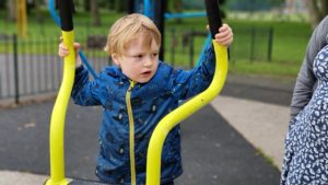 A boy on a cross-trainer.