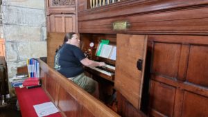 Ruth plays a pipe organ.