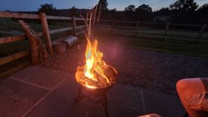 A fire pit rages and sparks.