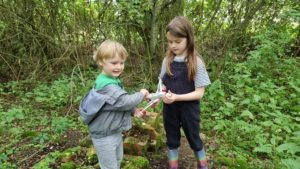 Children hold a toy plane with "geocache airlines" written on it.