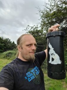 Dan holding the Wild Wolf 3 geocache.