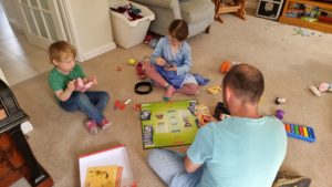 Children watch as our 7-year-old plays Pokemon with Simon.