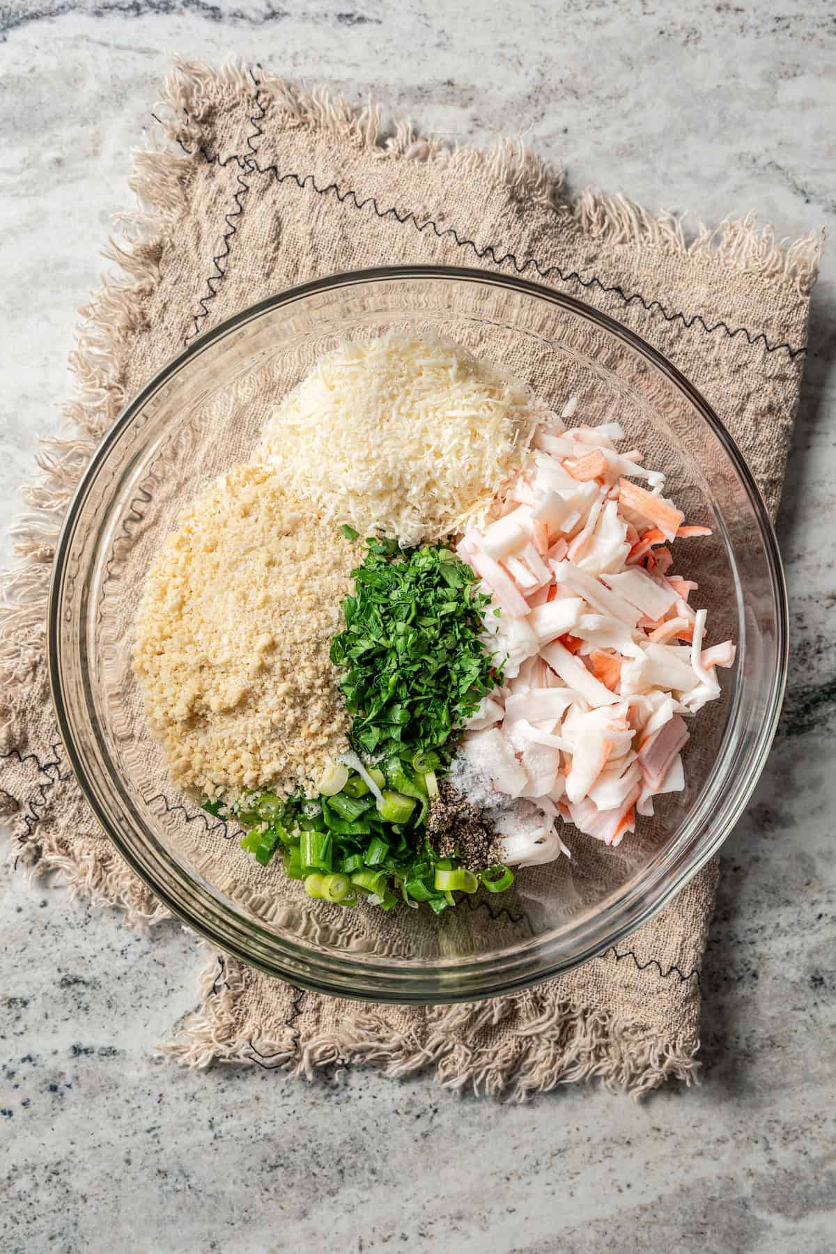 Crab filling ingredients combined in a glass bowl.