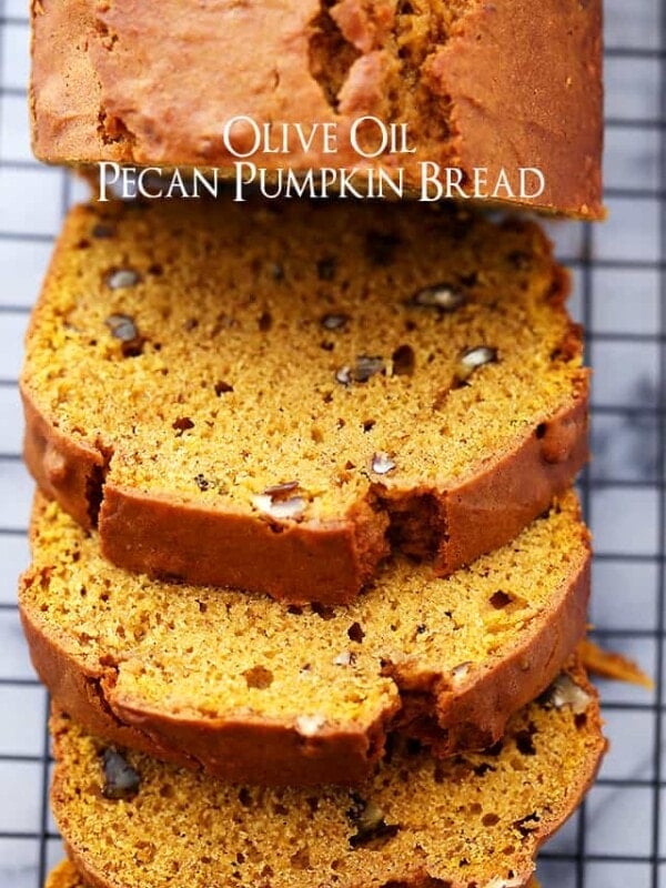 Overhead view of a pumpkin bread loaf cut into slices on a wire rack.