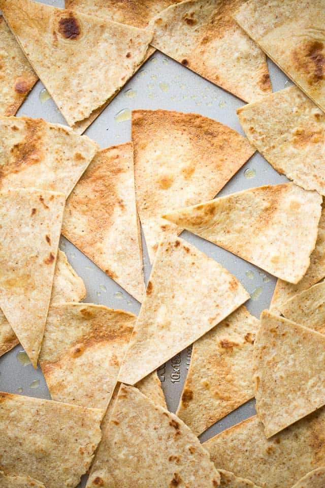 Overhead view of toasted tortilla wedges on a sheet pan.