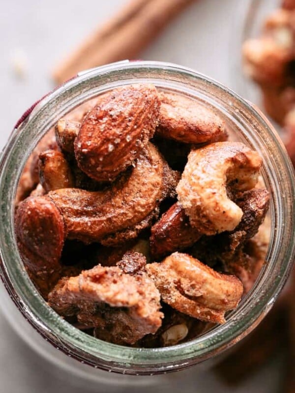 Close up overhead view of spiced nuts in a glass mason jar.