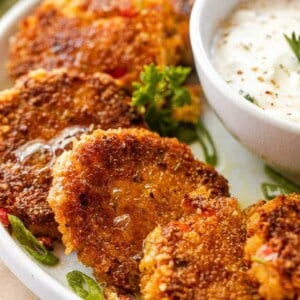 side shot of arranged crab cakes on a white plate