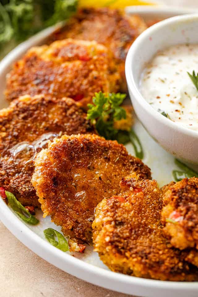 side shot of arranged crab cakes on a white plate