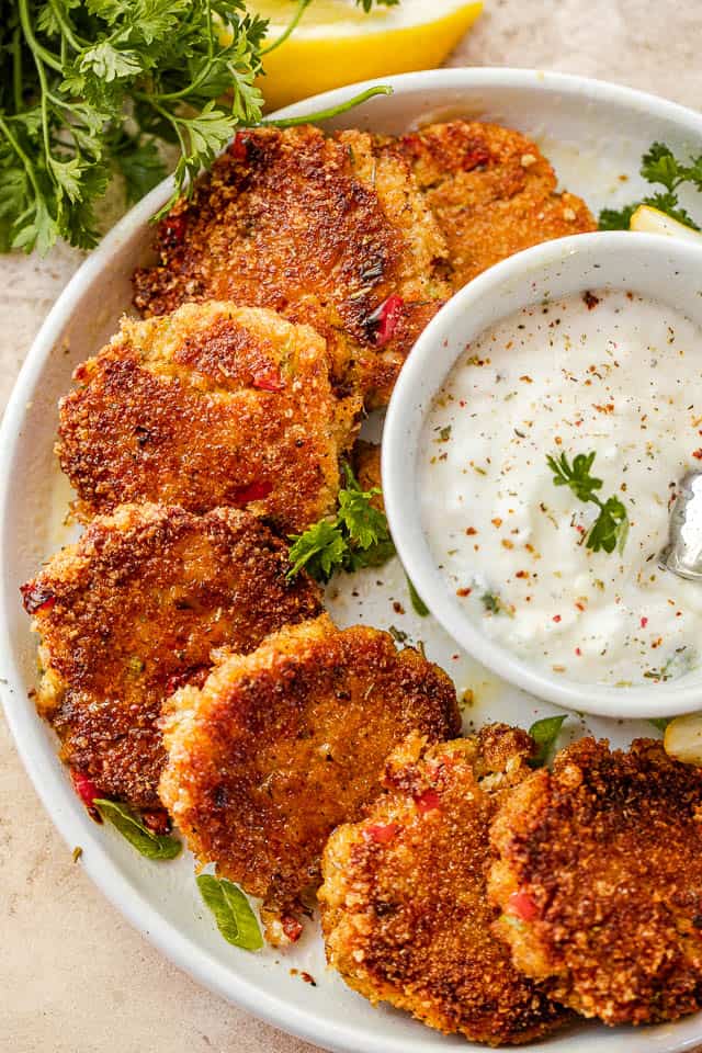 top shot of crab cakes served with yogurt dip