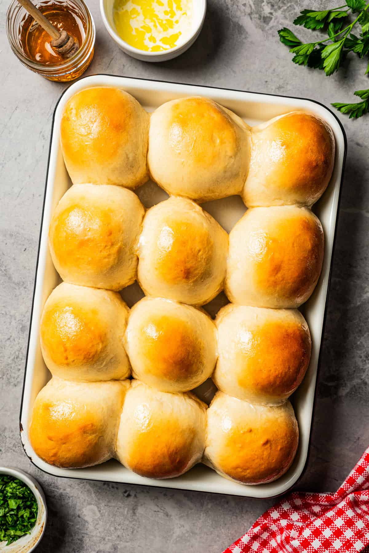 Freshly baked dinner rolls on a baking sheet.