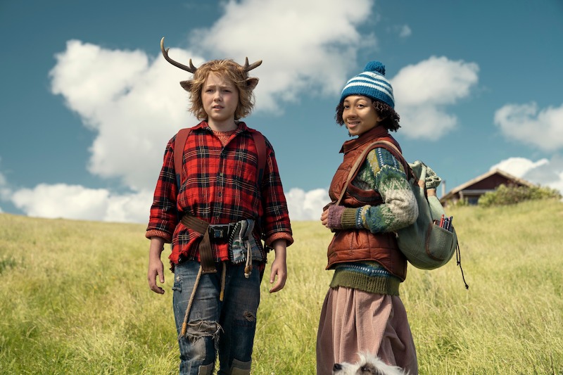 Christian Convery as Gus and Naledi Murray as Wendy stand on a grassy hill together in Season 3 of 'Sweet Tooth'