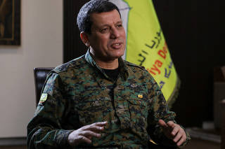 FILE PHOTO: Commander of Syrian Kurdish-led forces Mazloum Abdi attends an interview with Reuters in Hasakah