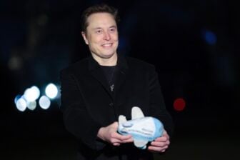 Elon Musk holds up an Air Force One stuffed toy as he walks from the presidential helicopter Marine One on the South Lawn of the White House on February 19, 2025 in Washington, DC.