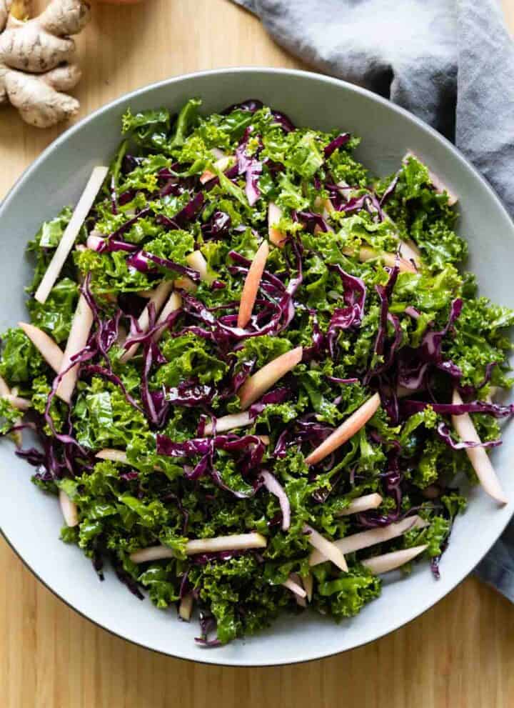 Simple kale salad in a light grey bowl.