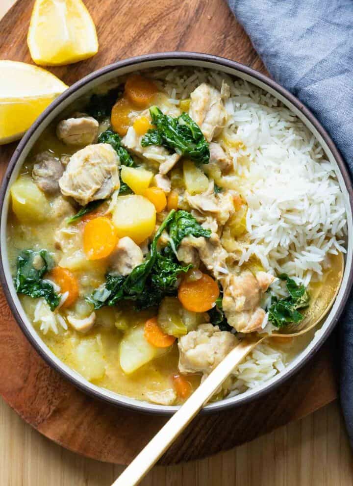 Instant Pot Chicken Stew served over rice in a bowl.