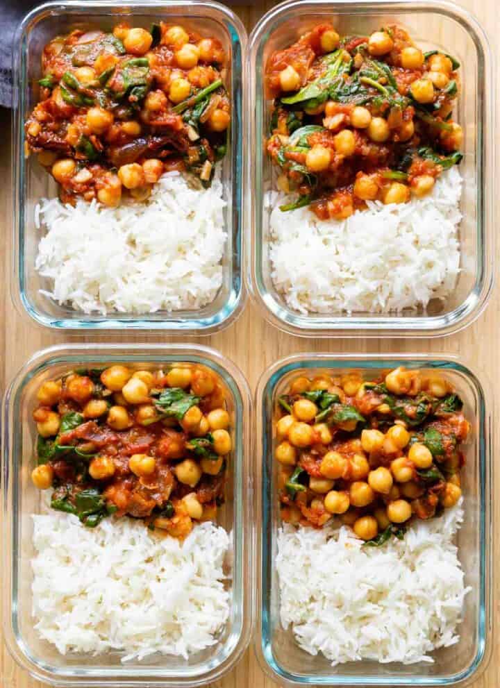 Four chipotle chickepe meal prep bowls next to each other showing white rice and chickpea stew.