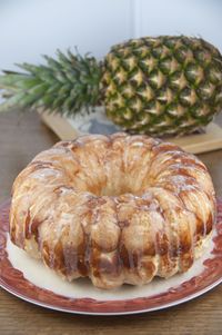 Hawaiian Bubble Bread: 1 teaspoon granulated sugar; 1/4 oz. package rapid/quick rise yeast; 1 cup warm water; 1 cup sliced ripe banana; 1/2 cup pineapple-orange-banana juice, concentrate undiluted; 1/2 cup honey; 2 tablespoons butter, melted; 5 cups bread flour, divided; 1 teaspoon salt. For the glaze: 1/2 cup cream of coconut; 4 tablespoons pineapple-orange-banana juice, concentrate undiluted; 1 cup sifted powdered sugar