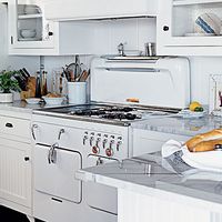 Love the white glass faced cabinets