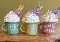 * Handmade *Material's include Faux whipped topping, faux sprinkles, mini mug Decription: These mini ceramic espresso mugs with faux whipped cream topping and sprinkles are a perfect addition to your Easter decor!  Add to your tiered trays, coffee bar or just as a general decoration.   These mugs measure roughly 4.5" high and 4" wide (as these are made to order height may vary a little).    Note:  Each mug is made to order so faux toppings may vary from pictures.                         **FOR DECORATION ONLY!  Faux whipped cream and sprinkles are NOT edible.