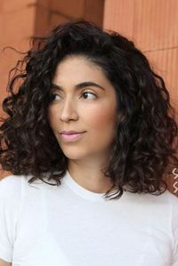 Let those ringlets run wild. From fringe-heavy shags to bouncy layered cuts, these hairstyles for long curly hair will give those ringlets room to shine. #beauty #beautytips #hair #hairtstyles #curlyhair #southernliving