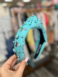 Brianna Cannon Get in the Yee Haw Spirit with this fun headband! Turquoise Headband with hand-sewn crystals, turquoise beads, and silver antiqued metal boots charms Turquoise Cowgirl Headband With Crystals & Enamel Boots Comfortable & perfect for everyday! Available in 2 colors.